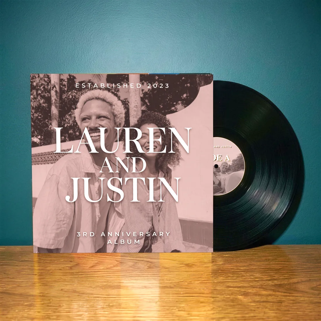 Customer-made custom vinyl record in its sleeve against a teal wall